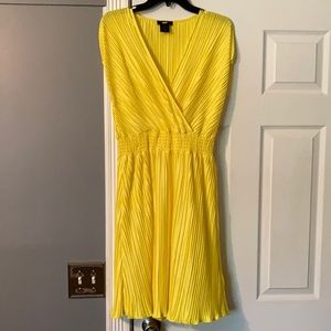 Dkny Mini Yellow dress with elastic waist band. Vneck line. Fits size  8- 12